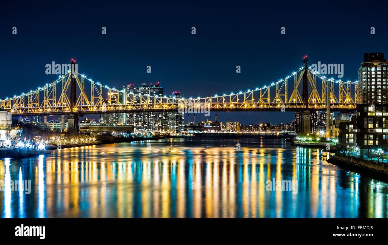 Ed Koch bridge (aka Queensboro bridge) as viewed by night from Roosevelt Island bridge in Queens, New York Stock Photo