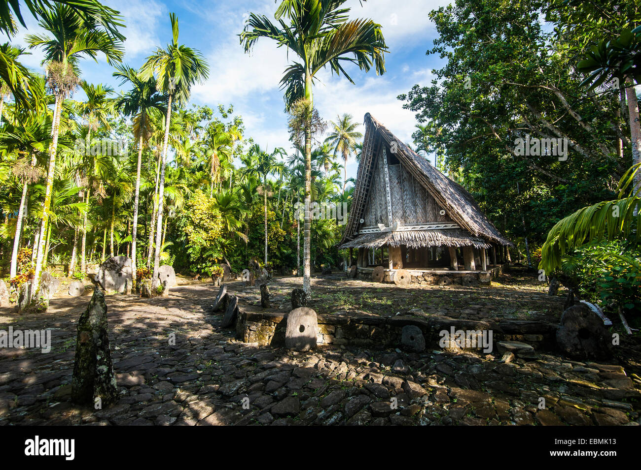Traditional house with stone money in front, Yap Island, Caroline Islands, Micronesia Stock Photo