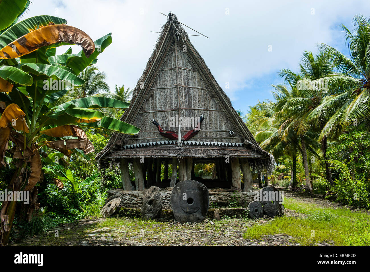 Traditional house with stone money in front, Yap Island, Caroline Islands, Micronesia Stock Photo