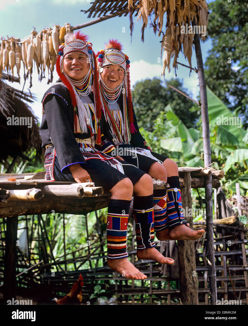 Young Akha girls in a mountain village, in traditional costume and headdress, Chiang Rai Province, Northern Thailand, Thailand Stock Photo