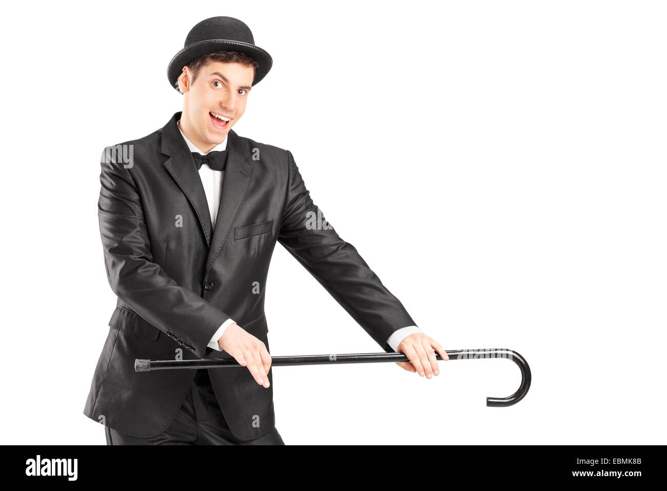 Male magician holding a cane isolated on white background Stock Photo