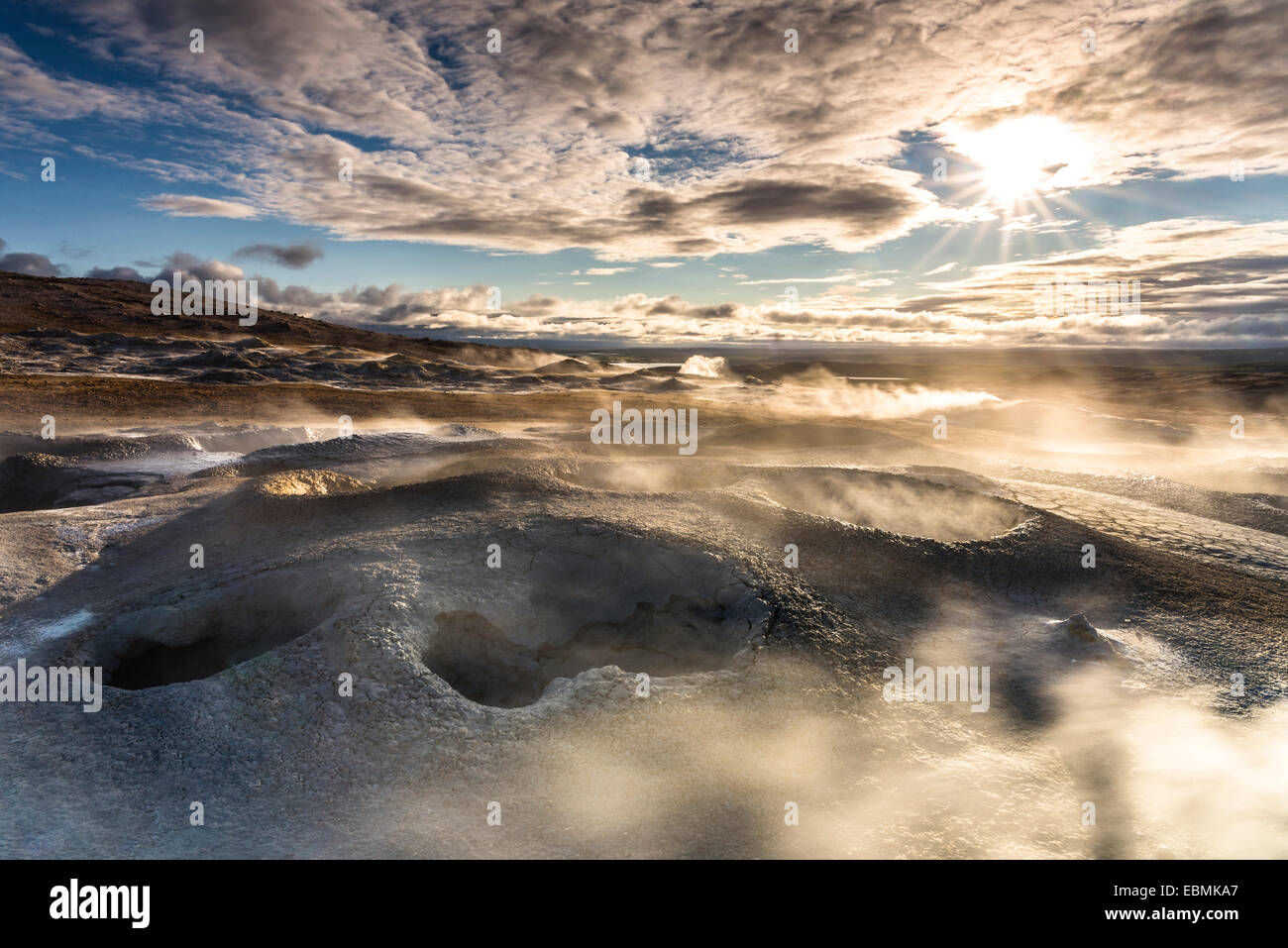 Solfataras, fumaroles, mud pots, sulfur and other minerals, vapor lights in the setting sun on the mountain Námafjall, Stock Photo