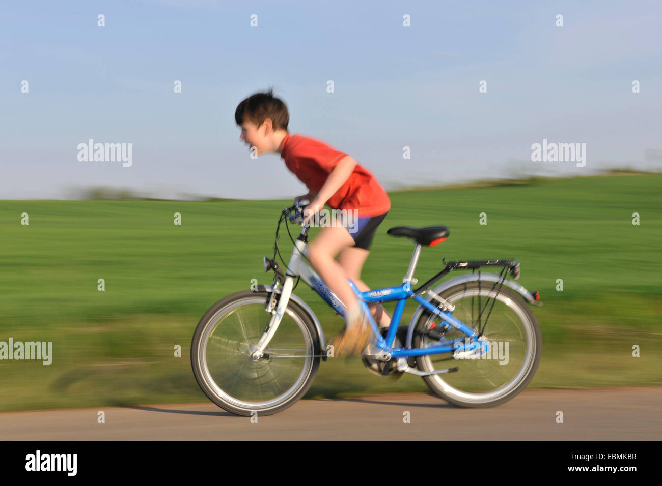 Boy riding a bicycle on a tarmaced track, Erfurt, Thuringia, Germany Stock Photo