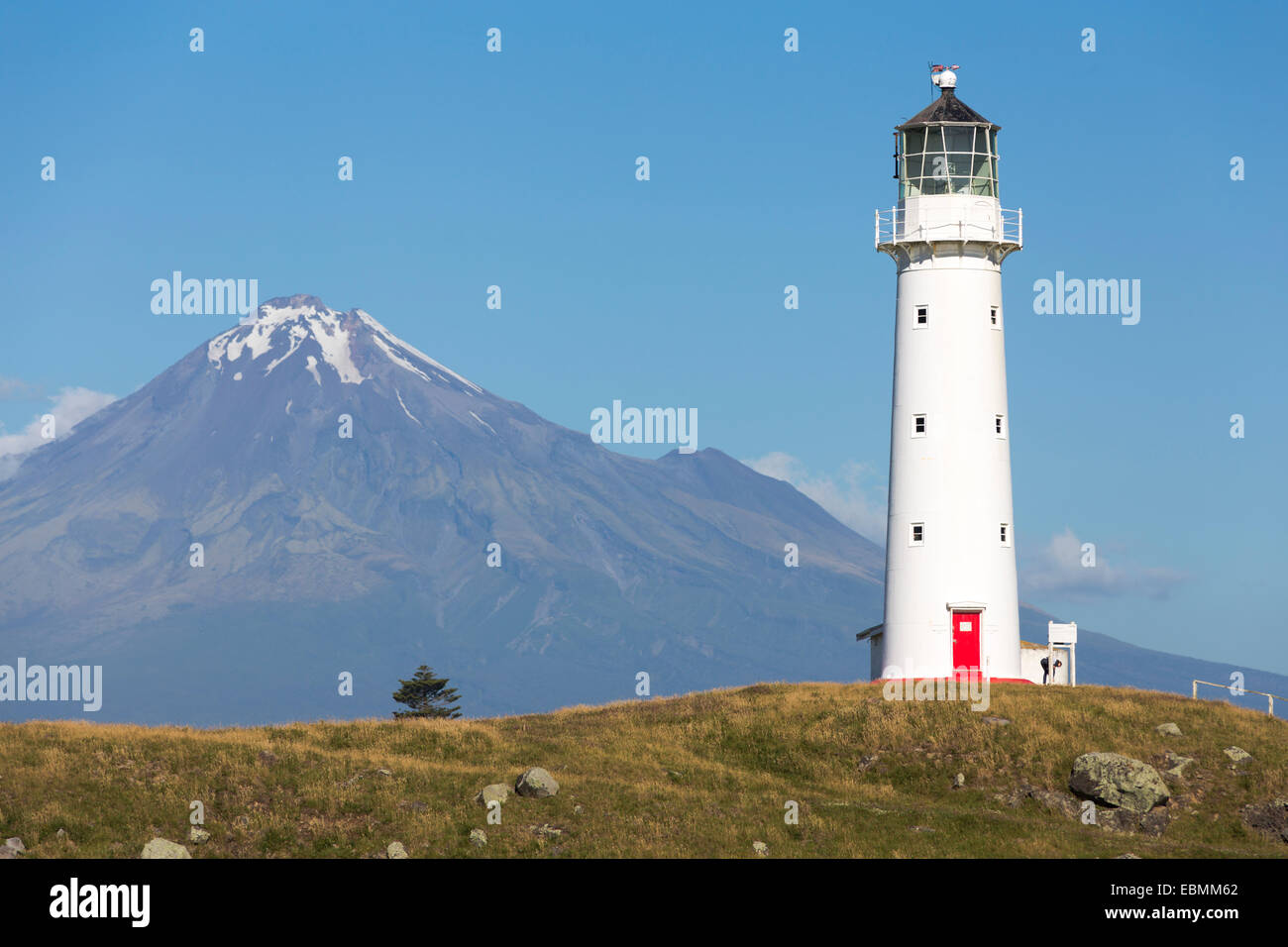 Cape Egmont Lighthouse with Mount Taranaki, Pungarehu, Taranaki Region, New Zealand Stock Photo