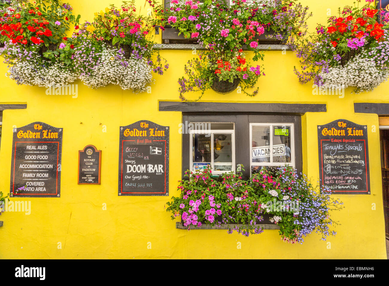 A close up view of the Golden Lion Hotel Padstow Cornwall with its beautiful summer flower baskets , cornwall England UK Stock Photo