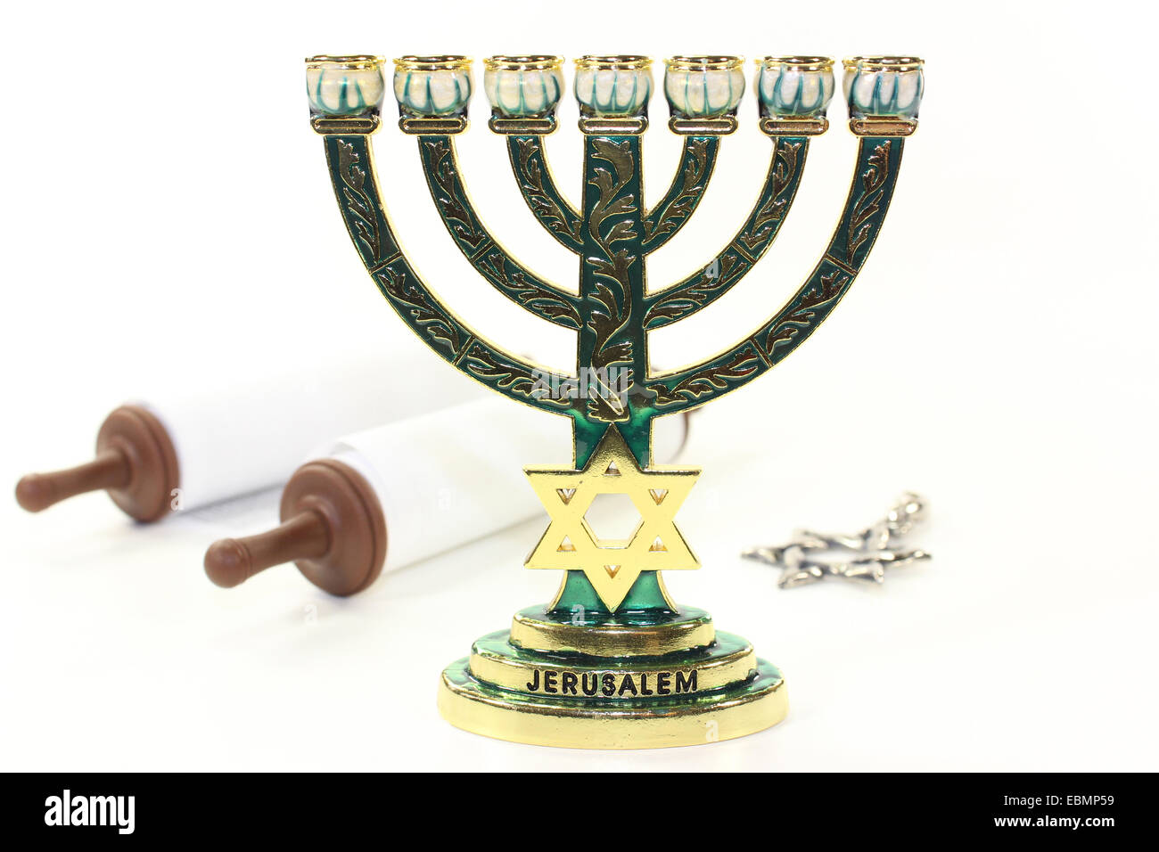 Jewish candlestick and Torah scroll in front of white background Stock