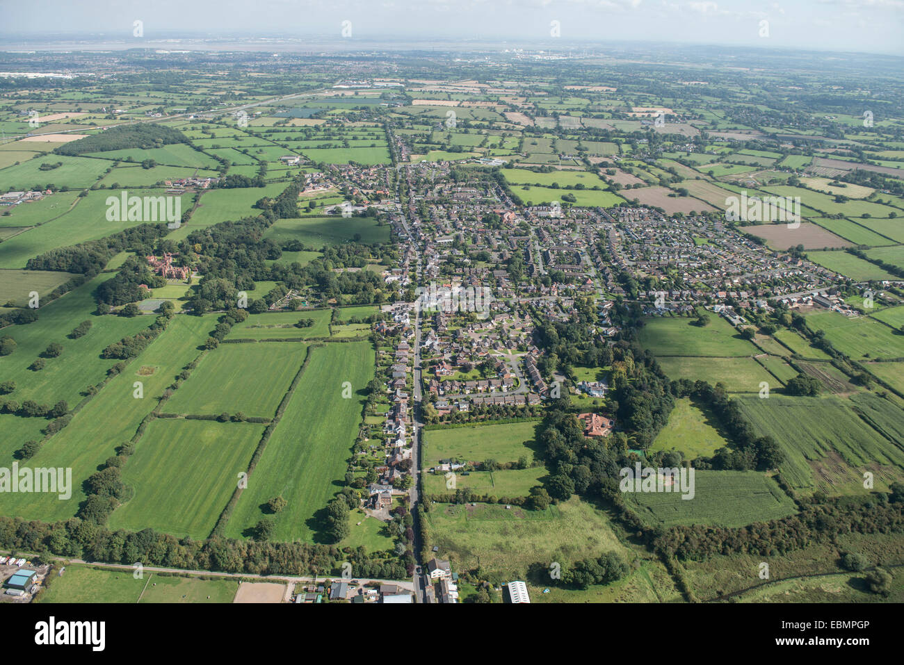 An aerial view of the Cheshire village of Saughall with surrounding countryside and Ellesmere Port visible in the distance Stock Photo