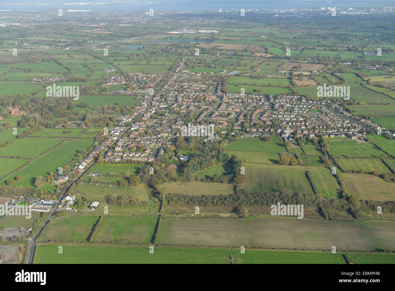An aerial view of the Cheshire village of Saughall with surrounding countryside and Ellesmere Port visible in the distance Stock Photo