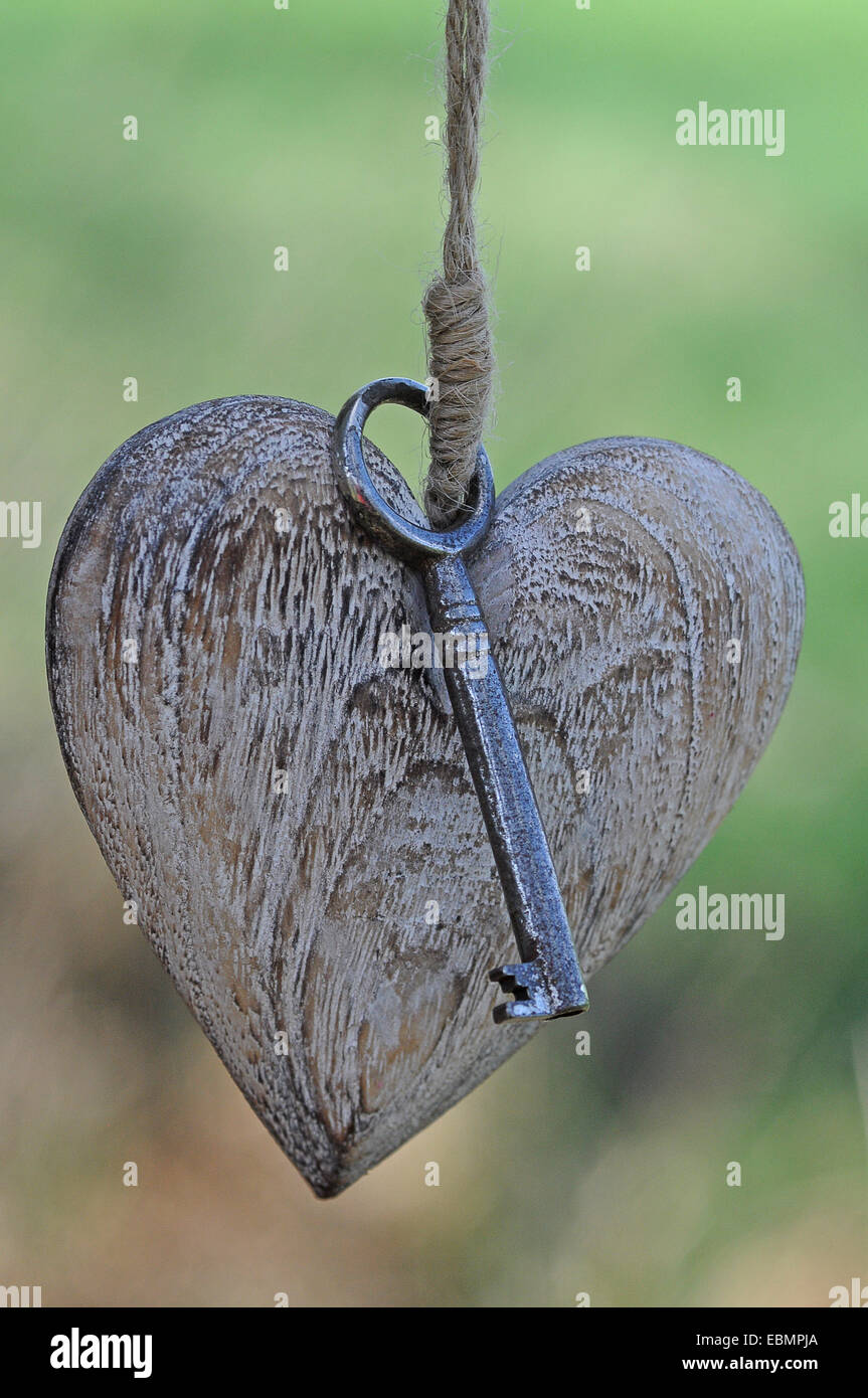 Wooden heart with a key Stock Photo