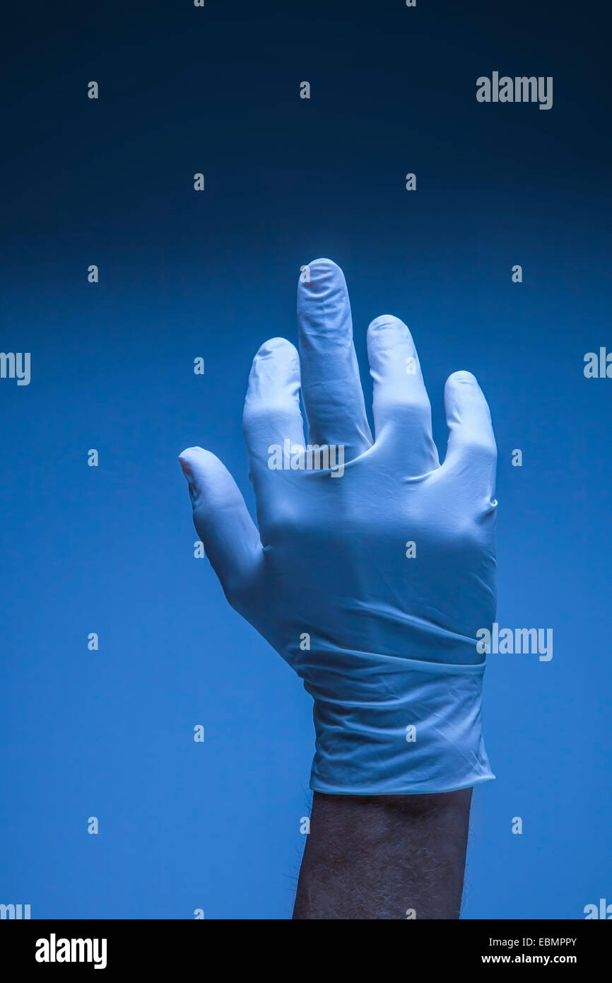 Hand in a surgical latex glove. Stock Photo