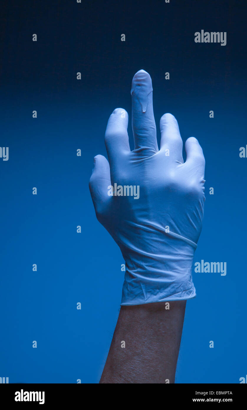 Hand in a lubricated surgical latex glove. Stock Photo