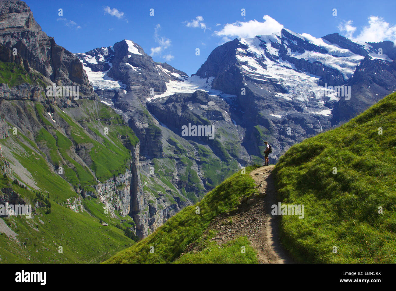 wanderer on a path in front of Doldenhorn near Kandersteg, Switzerland Stock Photo