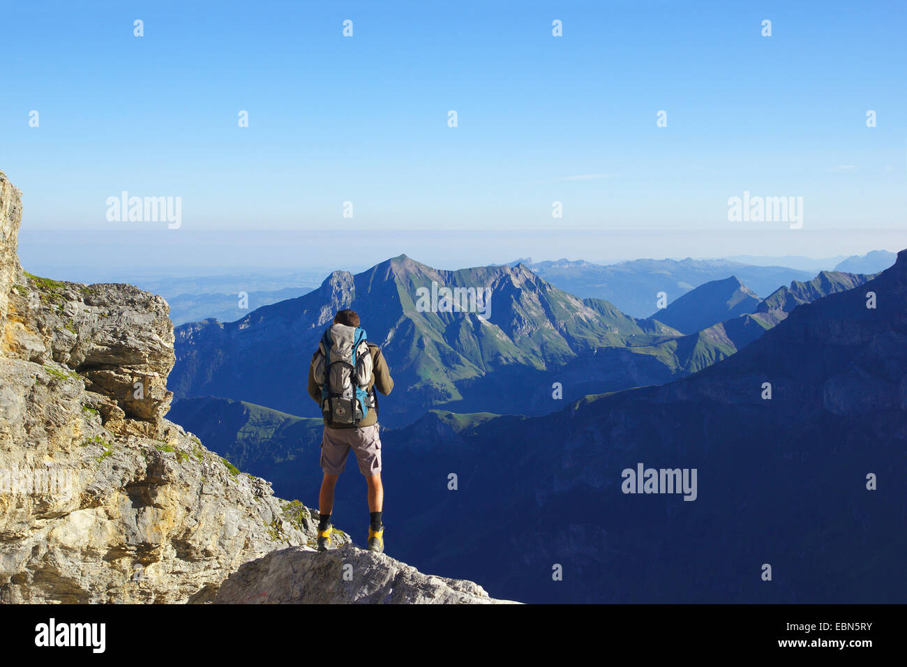 wanderer near the hut of the Bluemlisalp enjoying a good view, Switzerland Stock Photo