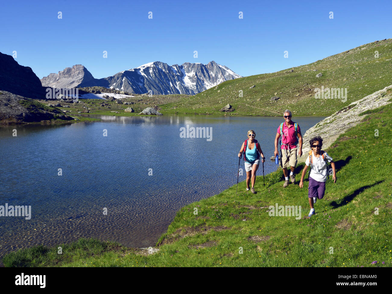 Family hiking along the lake of Moutons, France, Savoie, Vanoise National Park Stock Photo