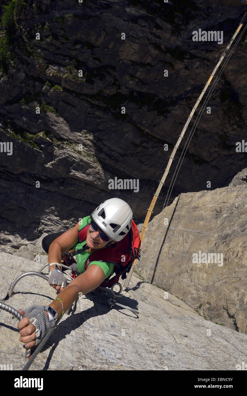 woman climbing at Via ferrata of Roc de Toviere, France, Savoie, Val d Isere Stock Photo