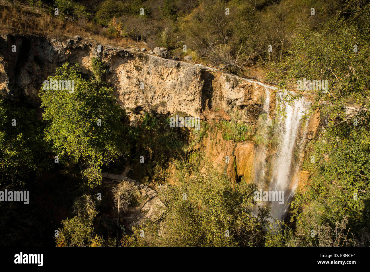 wooded hillsides with small waterfall , Kyrgyzstan, Djalalabad, Arslanbob Stock Photo