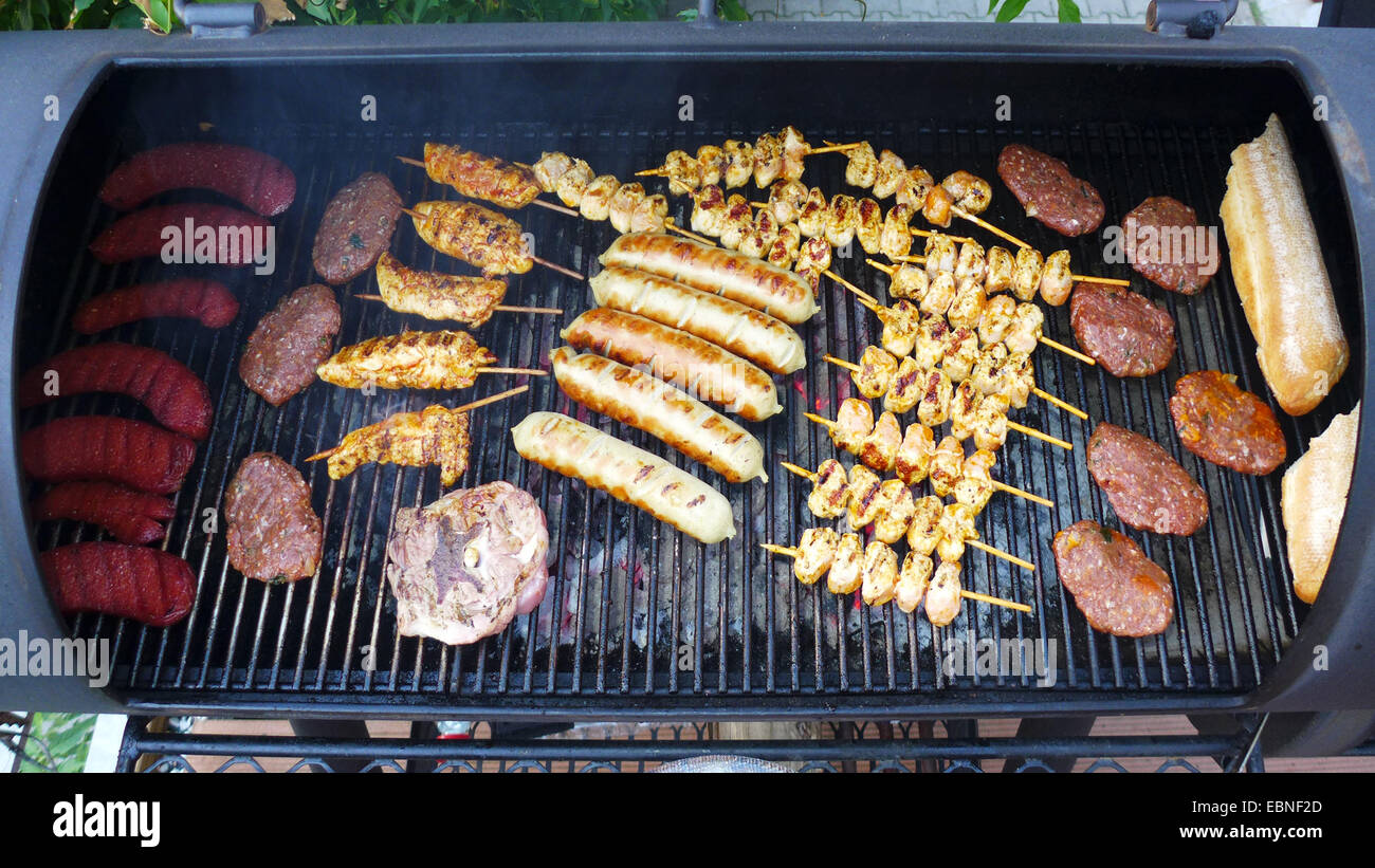 grill meat in a Barbecue-Smoker Stock Photo