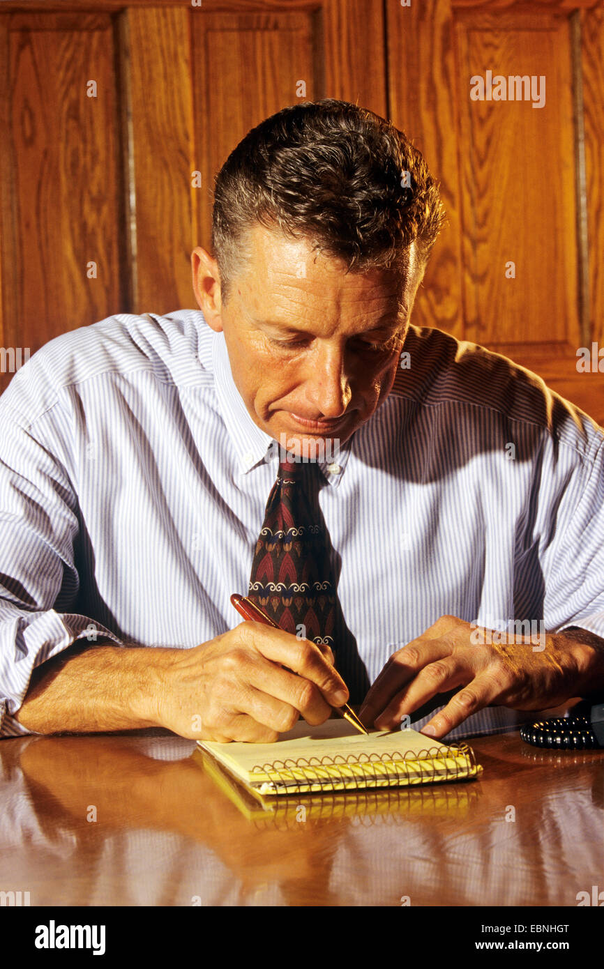 Jotted Businessman jotting ideas on notepaper (50's Stock Photo - Alamy
