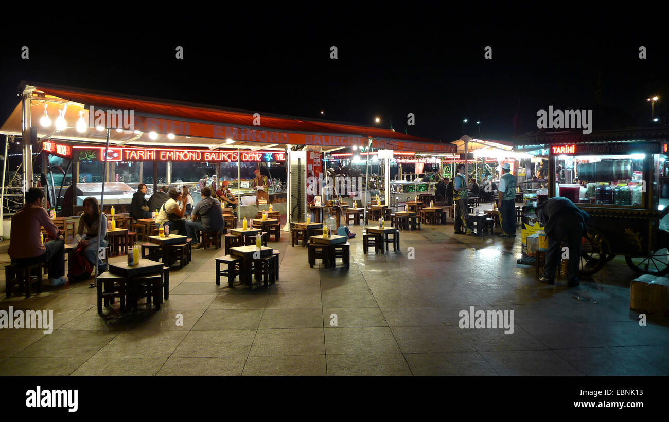 fish restaurant in historical harbour of Eminoenue at night, Turkey, Istanbul Stock Photo