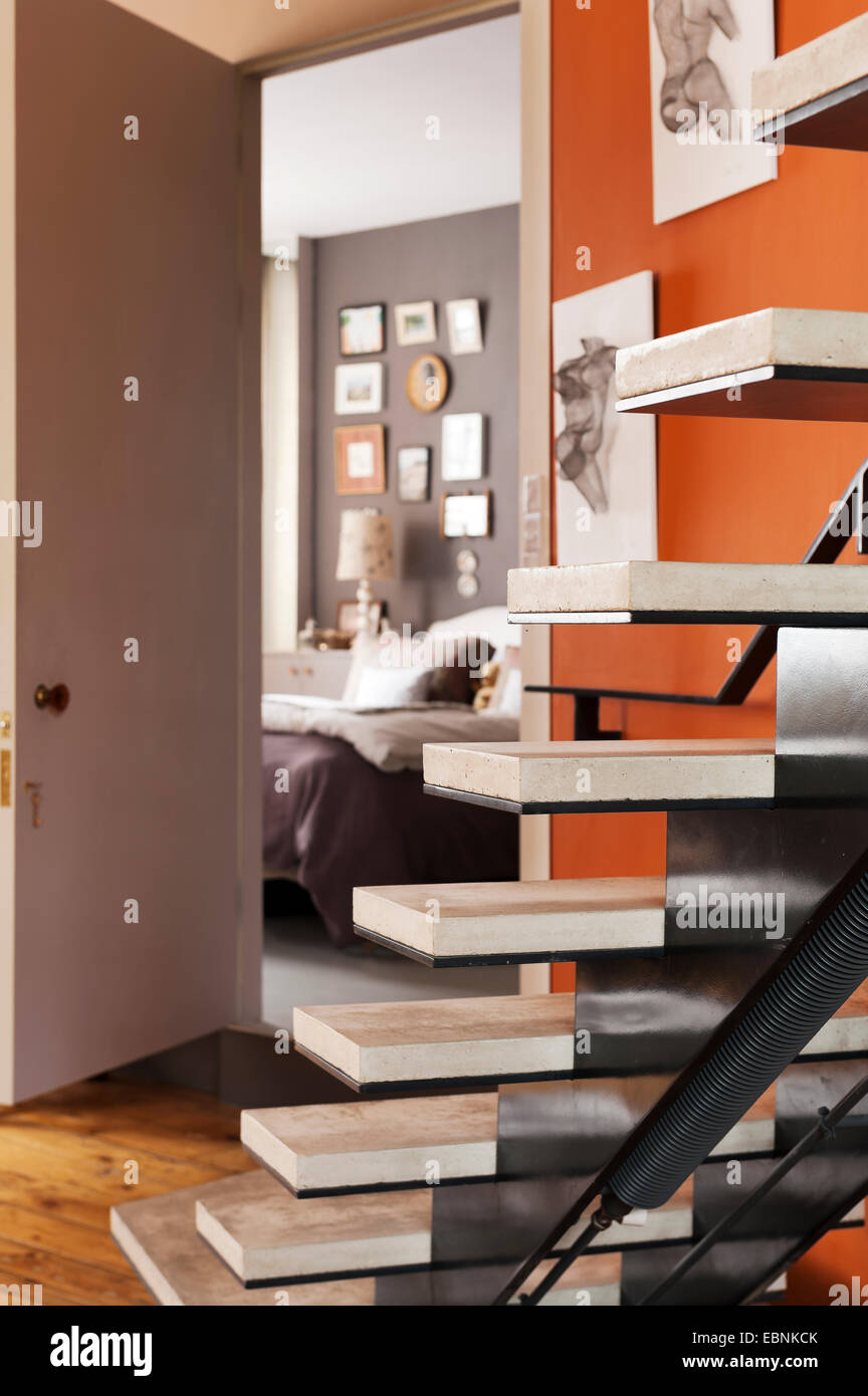 Open tread concrete stairs with view through to bedroom Stock Photo