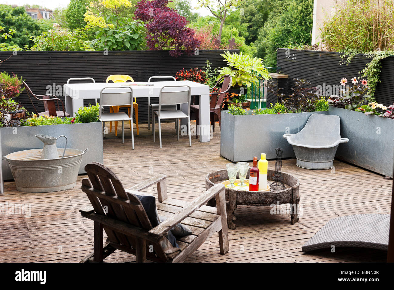 Wooden deck terrace with wooden furniture and tin baths Stock Photo