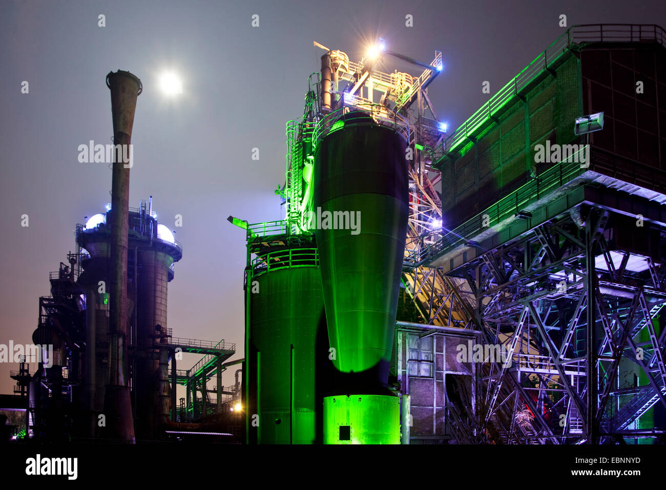 illuminated former steel mill and full moon at night, Landschaftspark Duisburg Nord, Germany, North Rhine-Westphalia, Ruhr Area, Duisburg Stock Photo