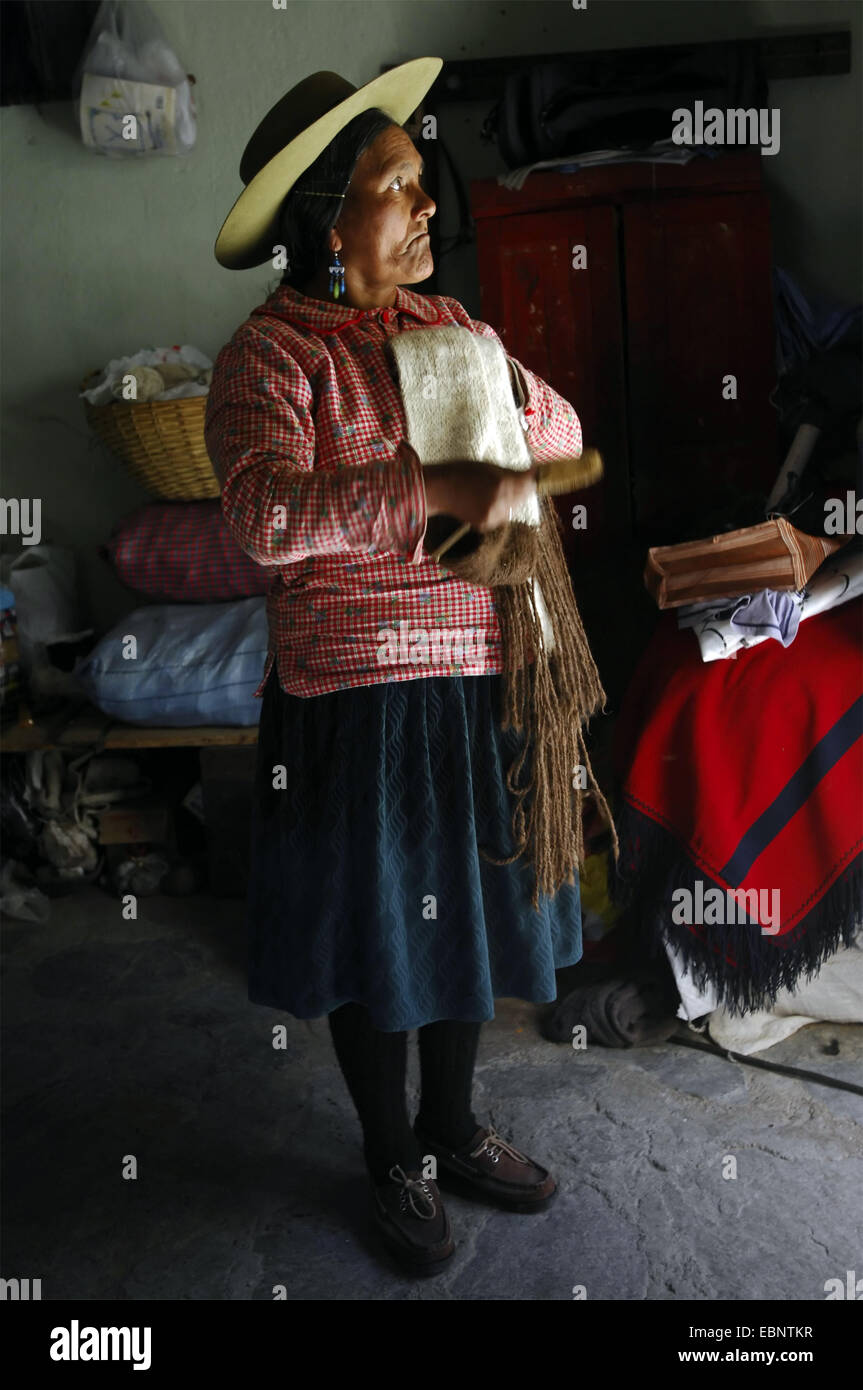 A woman brushing a scarf made with alpaca wool. Stock Photo