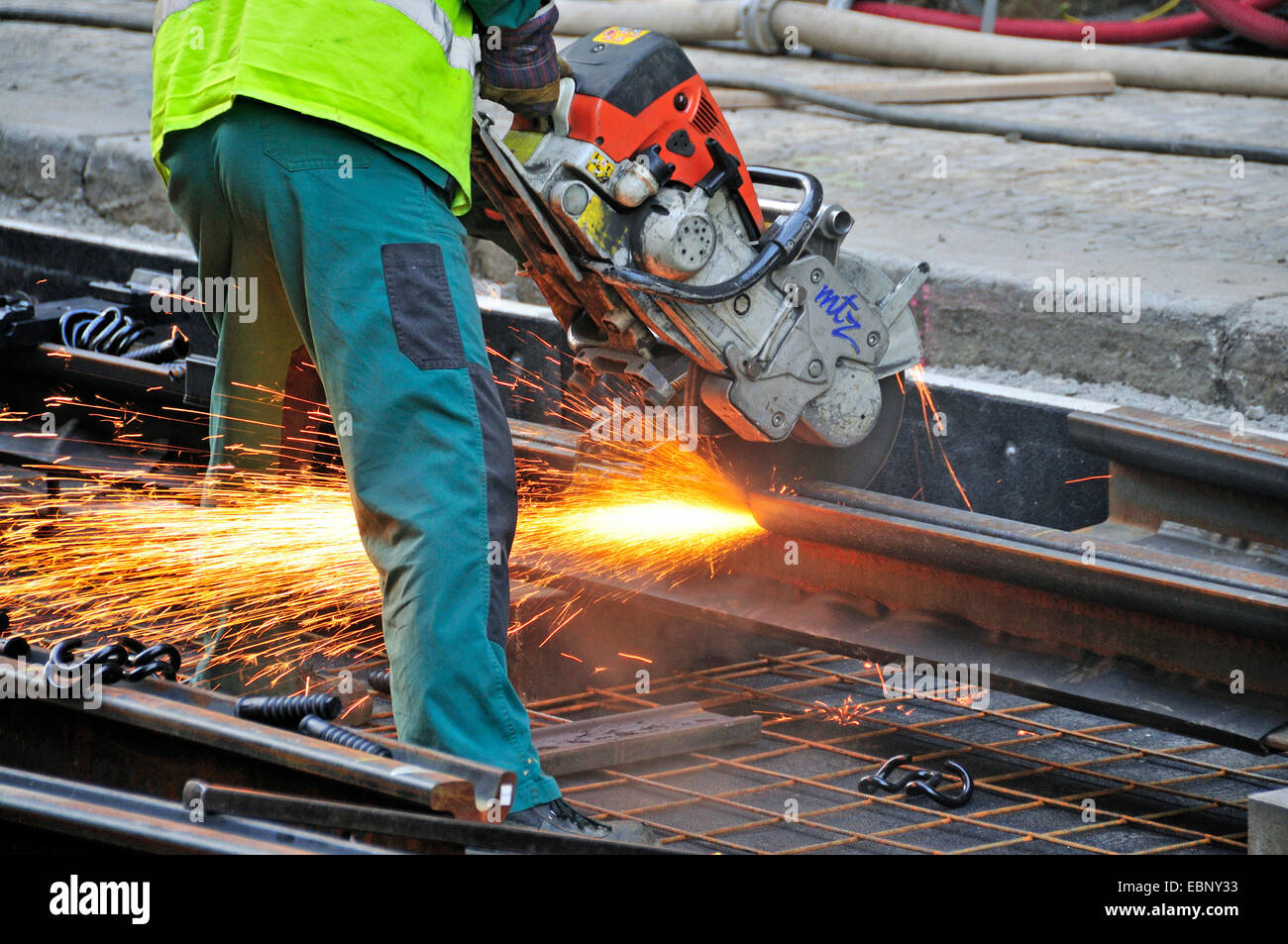 worker with abrasive cut-off machine working on tram lines, Czech ...
