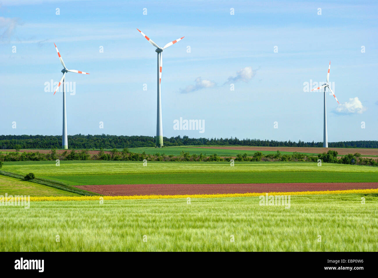 three wind wheels in field landscape in spring, Germany, Hesse Stock Photo