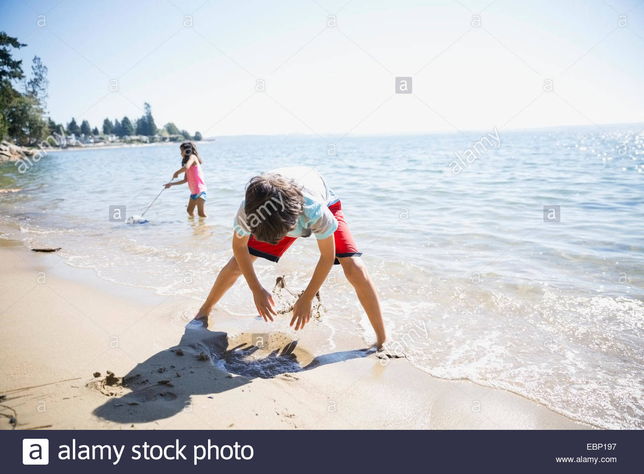 Boy girl clam digging on hires stock photography and images Alamy