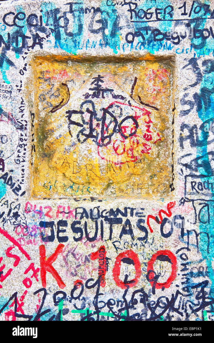 Way of St. James, detail of a milestone 100 at the way from Brea to Morgade with lots of pilgrims graffitis, Spain, Galicia, Lugo Stock Photo