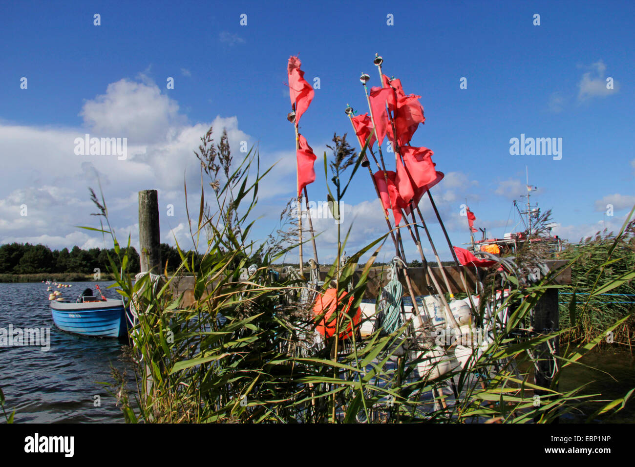 fishing boat, buoys and red flags for fishing nets in idyllic port of Darss, Germany, Mecklenburg-Western Pomerania, Prerow Stock Photo