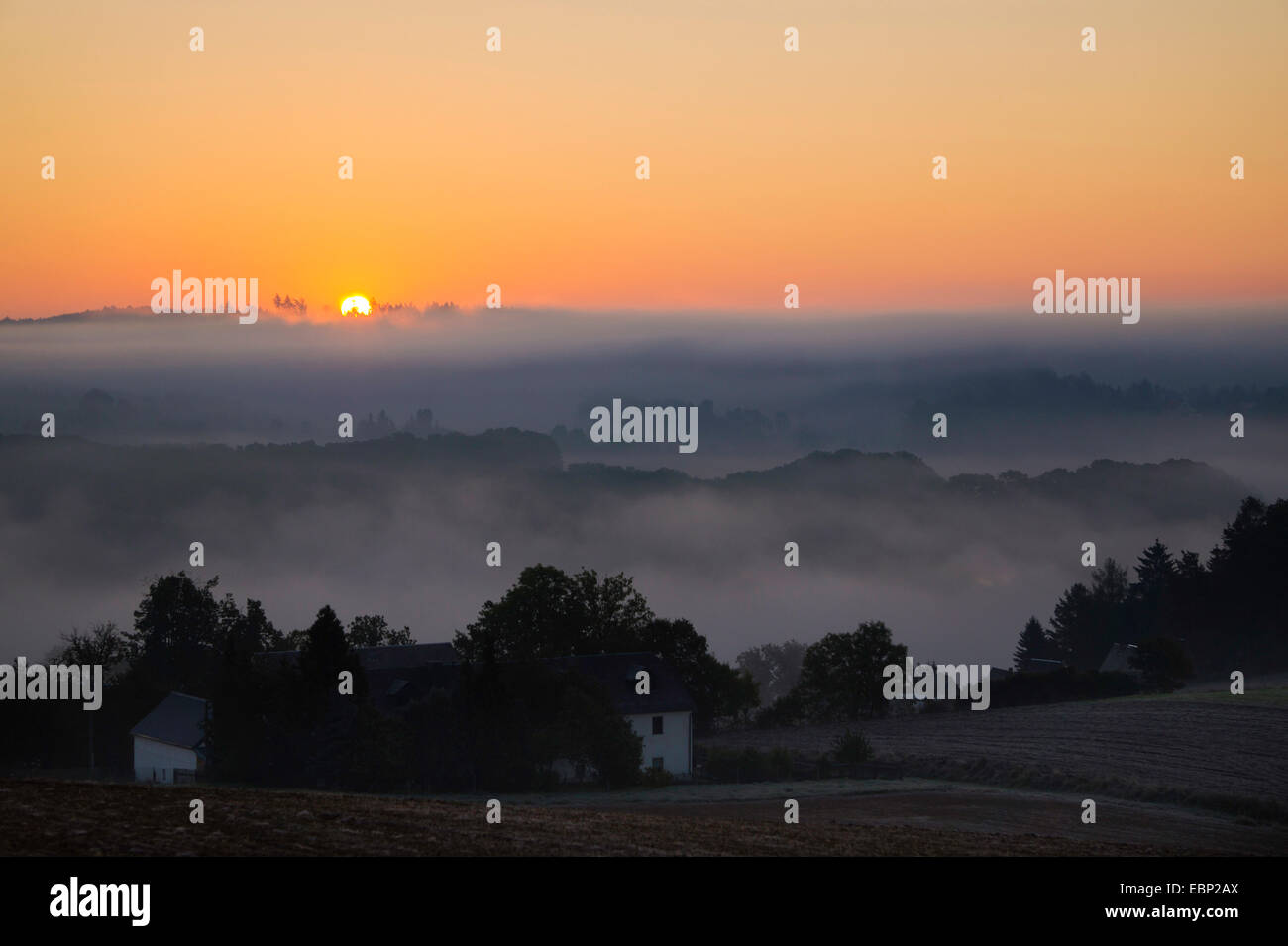 sunrise over a misty landscape in autumn, Germany, Saxony, Vogtland, Plauen Stock Photo