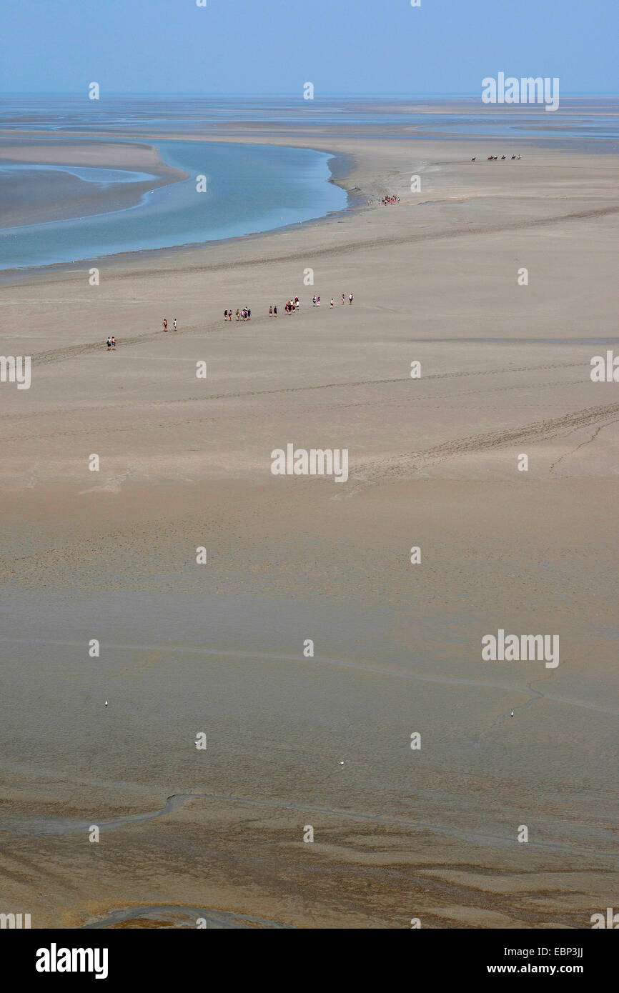 sandy tideland at low tide with tidal flat hikers, France, Brittany Stock Photo