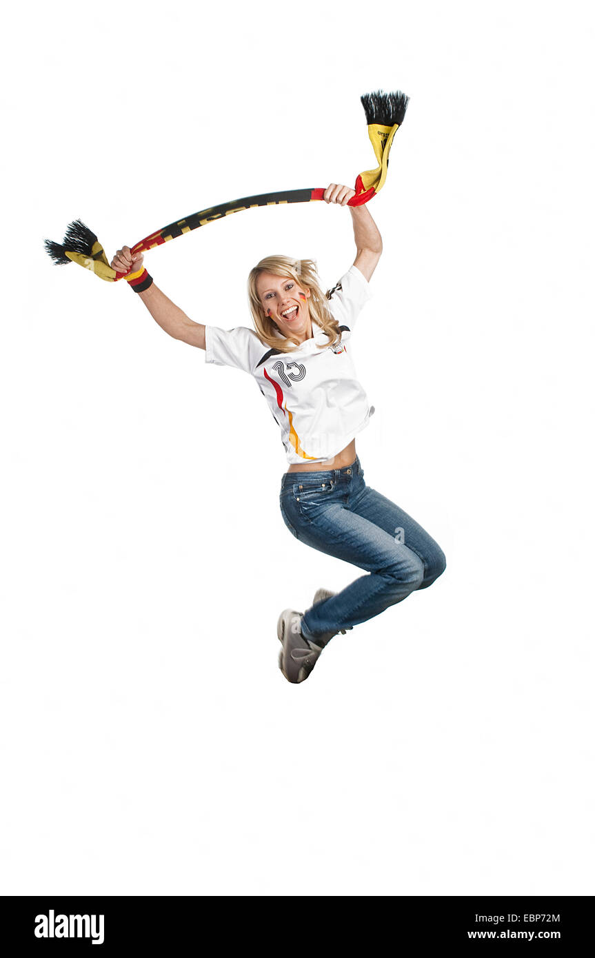 female soccer fan jumping in the air, Germany Stock Photo