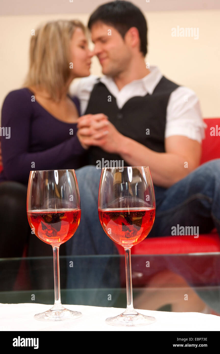 two wine glasses, lovers smooching in background, Germany Stock Photo