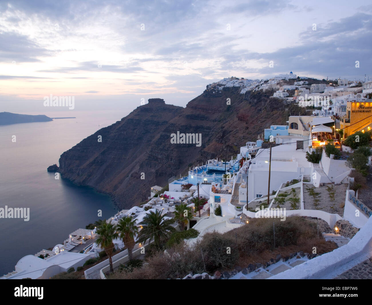 Firostefani, Santorini, South Aegean, Greece. View along the caldera rim at dusk, the rocky outcrop of Skaros prominent. Stock Photo