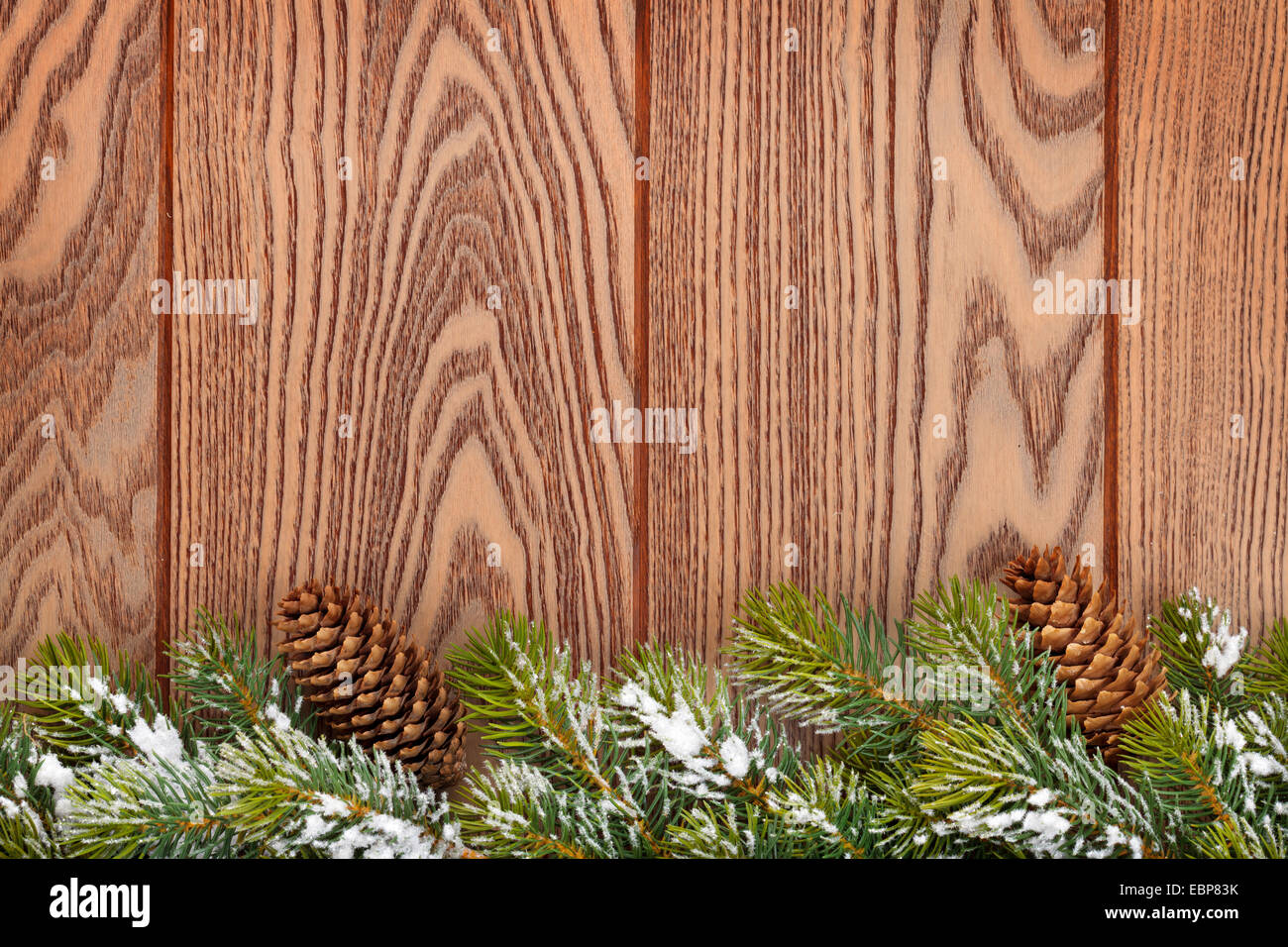 Christmas wooden background with snow fir tree and pinecones Stock ...
