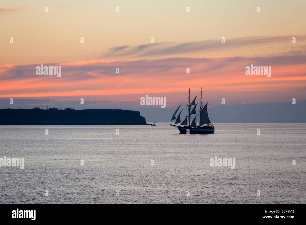 Ia, Santorini, South Aegean, Greece. Sailing ship passing in front of