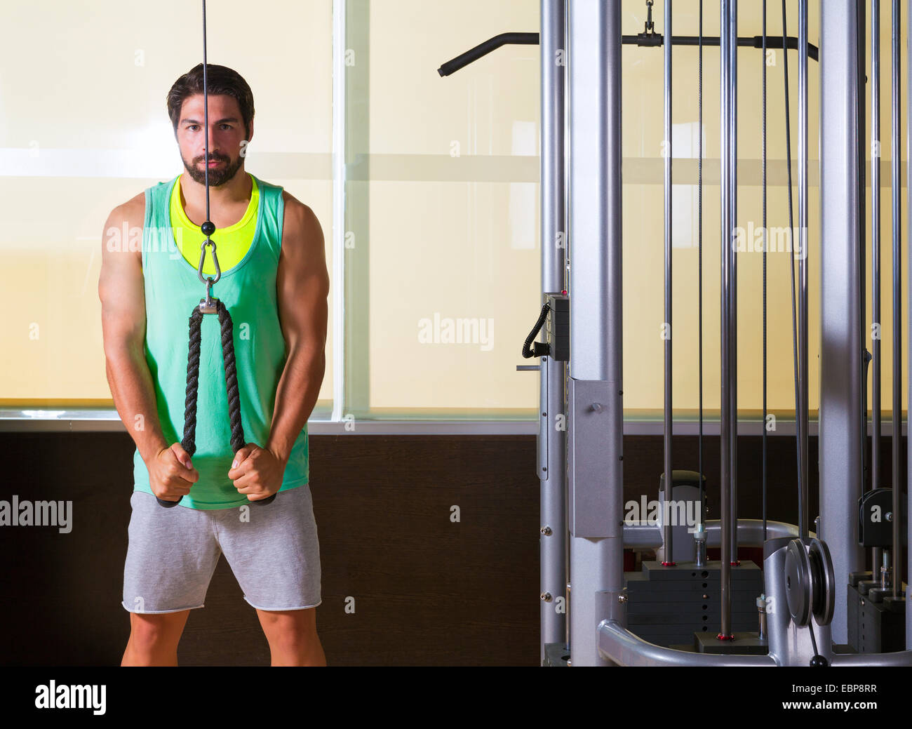 Triceps pressdown high pulley workout man at gym exercise Stock Photo