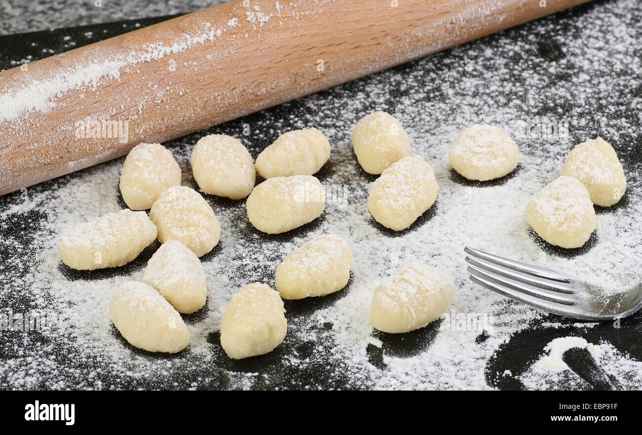 fresh gnocchi being prepared on a granite board Stock Photo