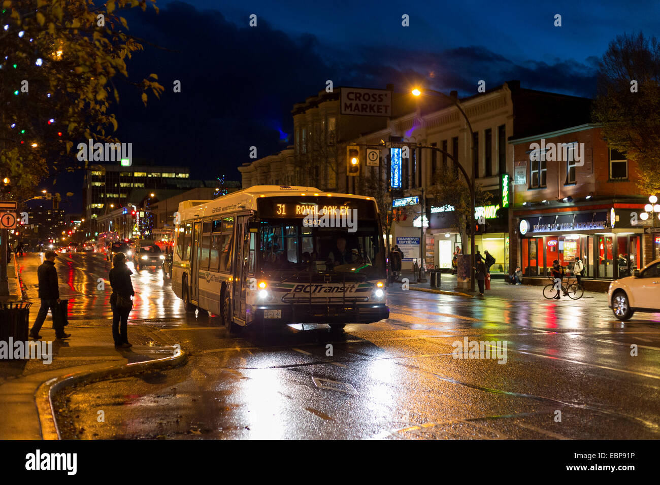 People walking in downtown Victoria on rainy night-Victoria, British Columbia, Canada. Stock Photo