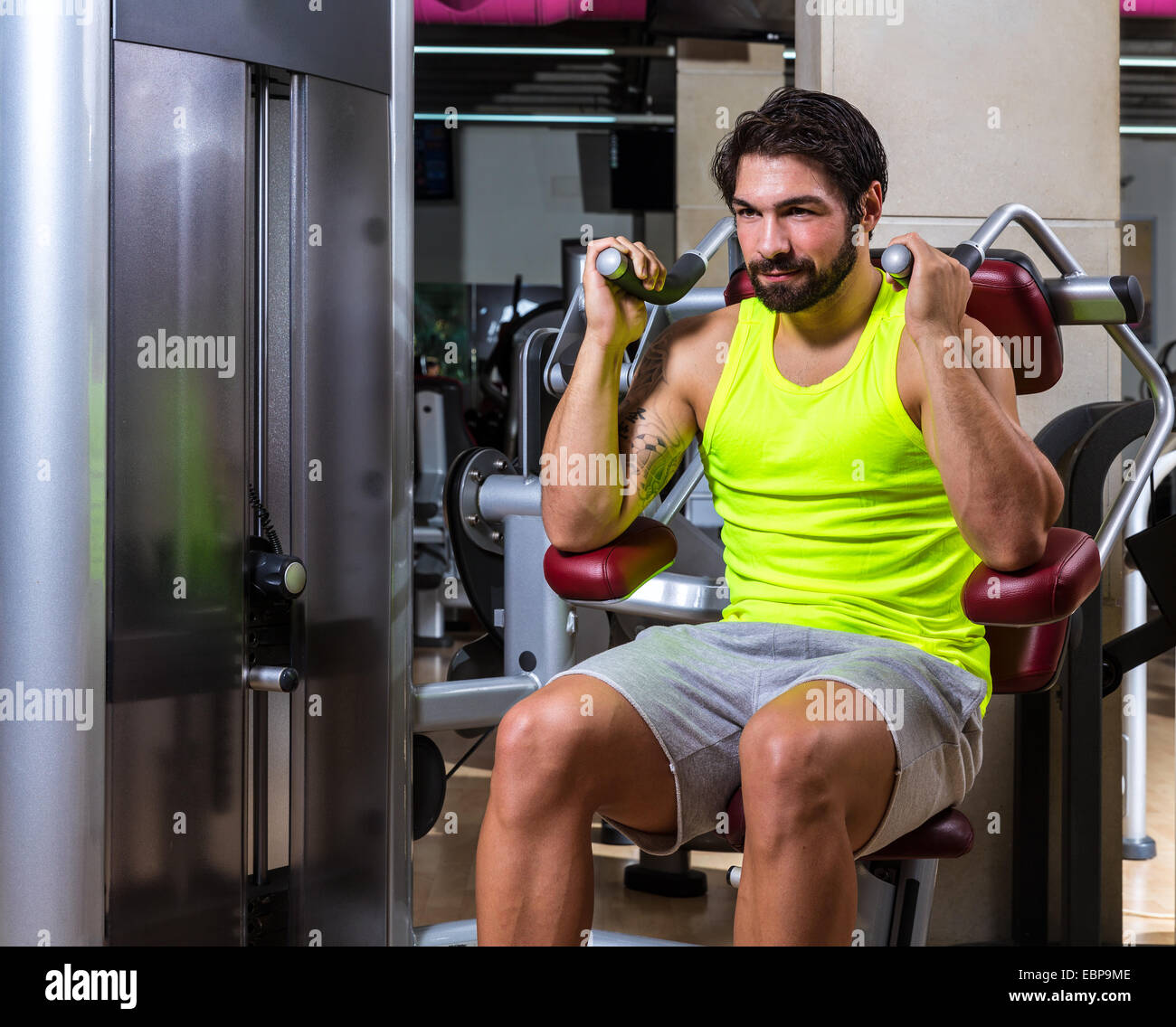 Abdominal crunch machine workout man sit at gym Stock Photo - Alamy