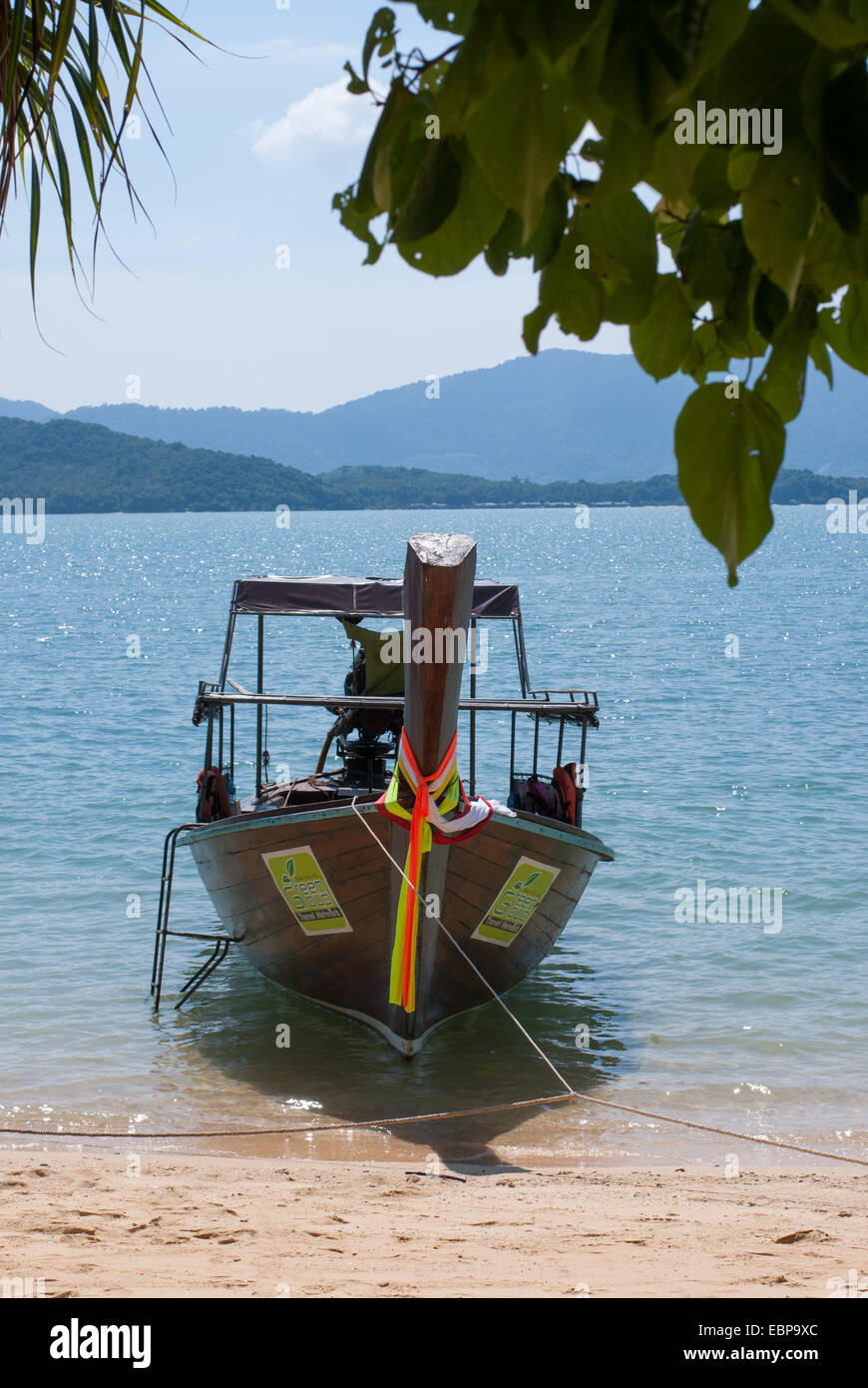 A longtail boat is parked on an exotic Thai beach Stock Photo