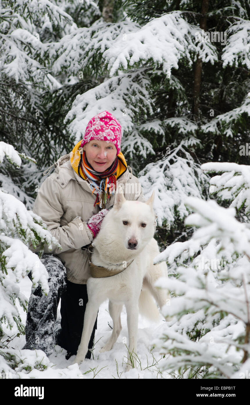The woman with a dog on walk in a winter wood Stock Photo - Alamy