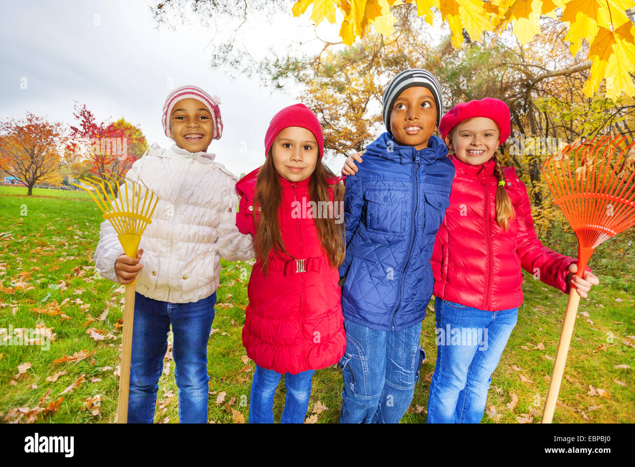 Group of happy cute kids with rakes stand in park Stock Photo - Alamy