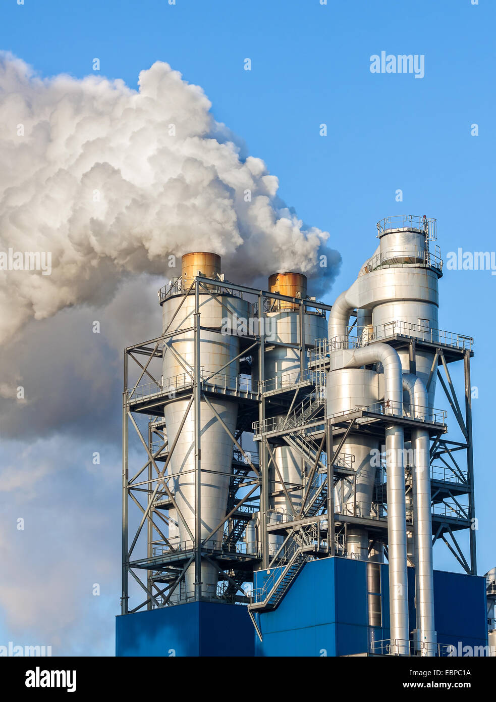Smoke clouds from a chimney against blue sky Stock Photo - Alamy