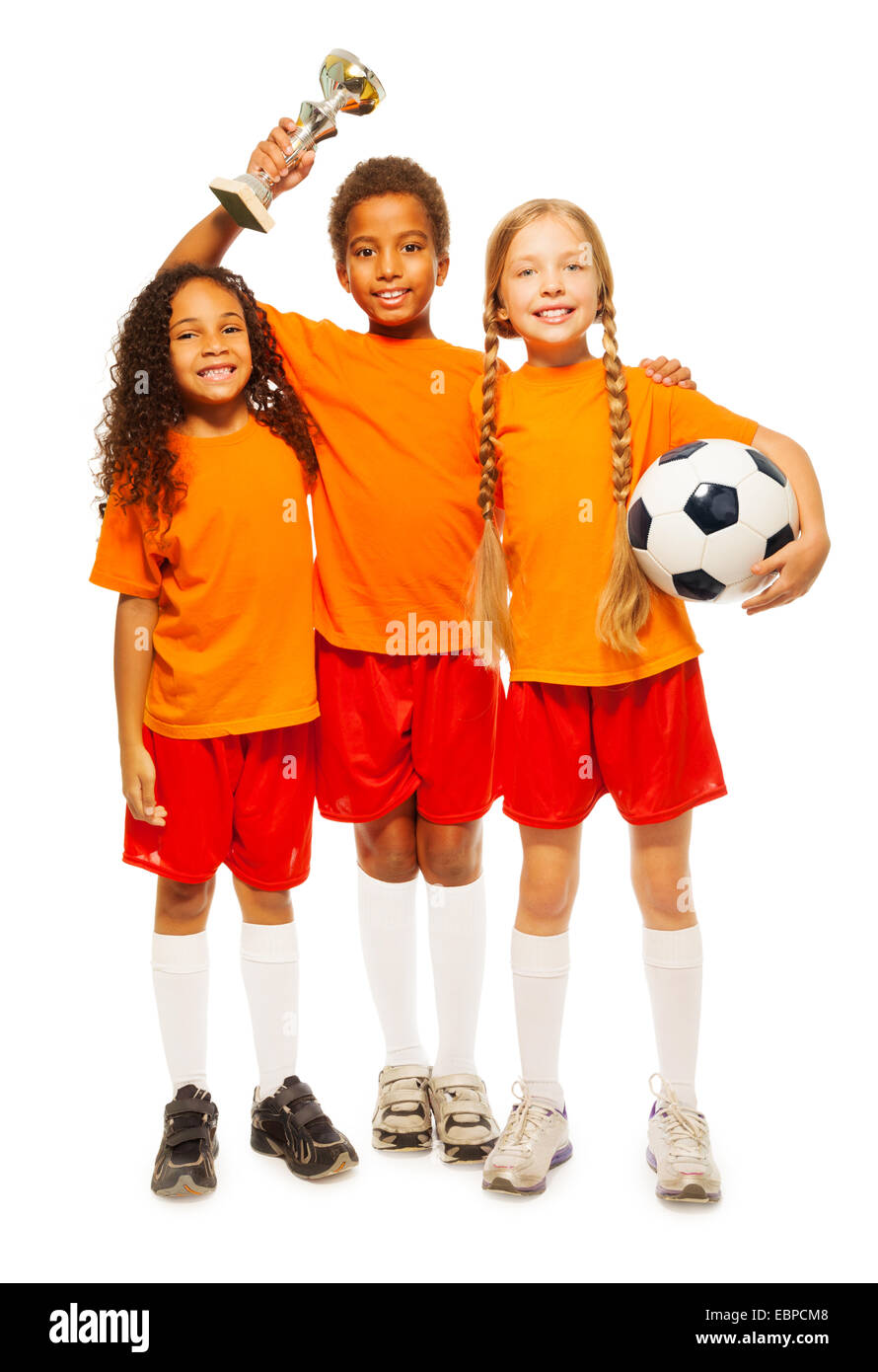 Happy kids winners of soccer game with prize cup Stock Photo