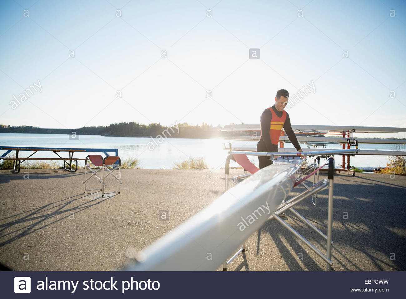 Rower with scull at waterfront Stock Photo