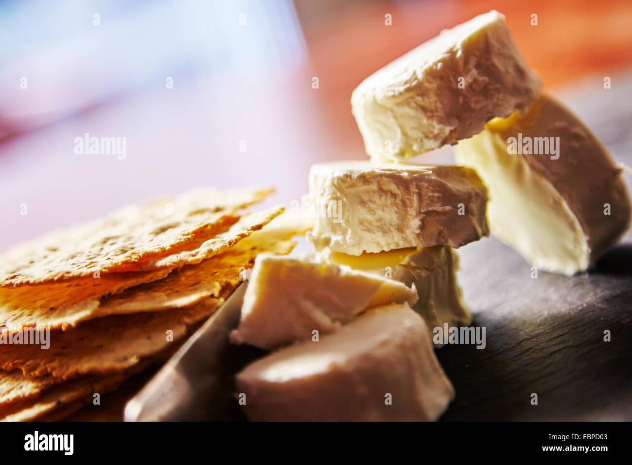 Organic French farmers goat cheese cut with a knife on a cheese board